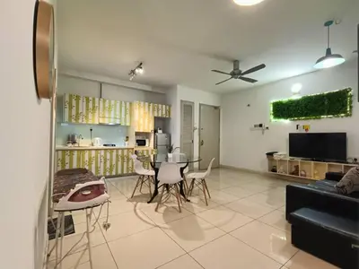 a living room with a table and chairs in it at VR3 Sunway Velocity Spacious Apt\u4e2d\u6587\u623f\u6771 in Kuala Lumpur