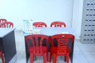 a table with red chairs in a room at Alaman Luxe suites KLCC in Kuala Lumpur