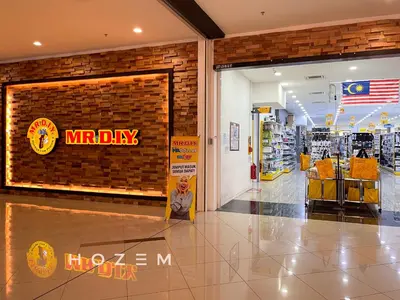 a man sitting in front of a mr day sign in a store at 3BR3B Hozem KL4523 Apartment Segambut in Kuala Lumpur