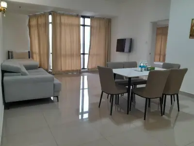 a living room with a table and chairs and a couch at Times Square Suite KL in Kuala Lumpur