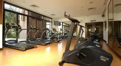 a row of exercise bikes in a gym at Times Square Suite KL in Kuala Lumpur