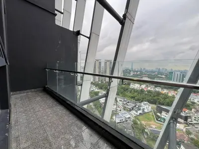 a balcony in a building with a view of a city at Arte Mont Kiara By Luxe Home in Kuala Lumpur