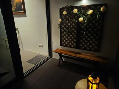 a bathroom with a bench with flowers on the wall at Scenic Garden Balcony EST Bangsar Studio for 2 in Kuala Lumpur