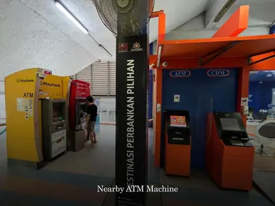 a person is standing next to an atm machine at Scenic Garden Balcony EST Bangsar Studio for 2 in Kuala Lumpur