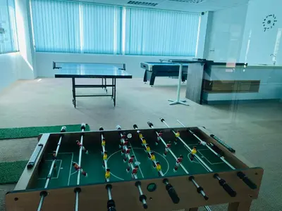 a ping pong table in a room with ping pong balls at VUE Residences Hkl Klcc view in Kuala Lumpur