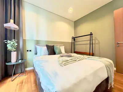 a bedroom with a large bed in a room at Sky Suites Chill 3BR Suite at KLCC in Kuala Lumpur