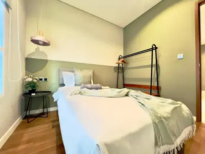 a bedroom with a large white bed in a room at Sky Suites Chill 3BR Suite at KLCC in Kuala Lumpur