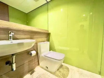 a bathroom with a toilet and a sink and a shower at Sky Suites Chill 3BR Suite at KLCC in Kuala Lumpur
