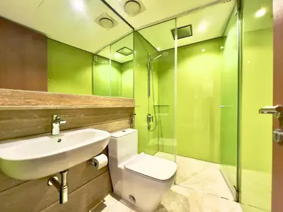 a bathroom with a toilet and a sink and a shower at Sky Suites Chill 3BR Suite at KLCC in Kuala Lumpur