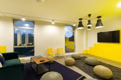 a living room with a couch and a tv at Upstairs Downstairs CoLiving Kampung Pandan in Kuala Lumpur