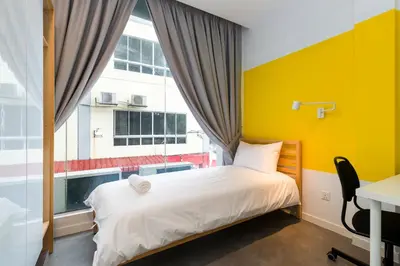 a bedroom with a bed and a large window at Upstairs Downstairs CoLiving Kampung Pandan in Kuala Lumpur