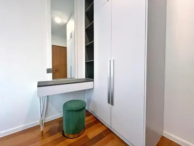 a dressing room with a mirror and a green stool at Sky Suites Dreamy 3BR Suite at KLCC in Kuala Lumpur