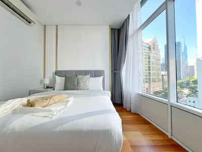 a bedroom with a large white bed and a large window at Sky Suites Dreamy 3BR Suite at KLCC in Kuala Lumpur