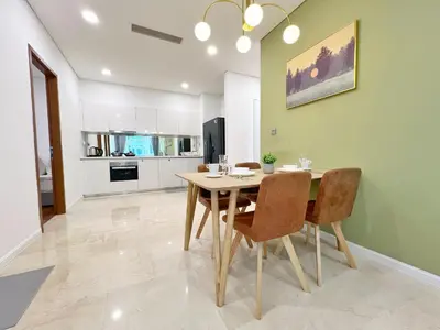 a kitchen and dining room with a table and chairs at Sky Suites Dreamy 3BR Suite at KLCC in Kuala Lumpur