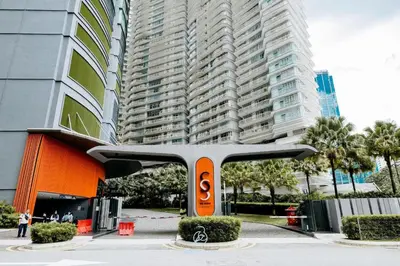 a sculpture in front of a tall building at Sky Suites KLCC by ARBA in Kuala Lumpur