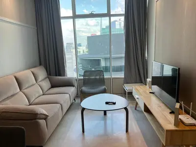 a living room with a couch and a large window at Sky Suites KLCC by ARBA in Kuala Lumpur