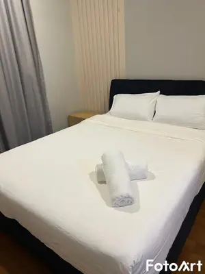 a bed with two rolls of paper towels on it at Sky Suites KLCC by ARBA in Kuala Lumpur