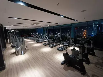 a gym with a row of treadms and cardio machines at COL 18A Modern Balcony KLCC View Infinity Pool in Kuala Lumpur