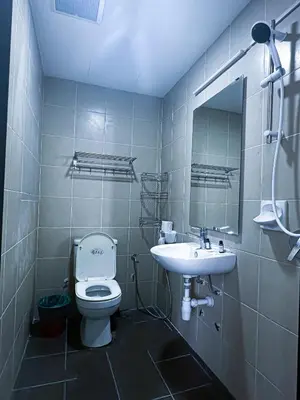 a bathroom with a toilet and a sink at Taragon Bukit Bintang in Kuala Lumpur