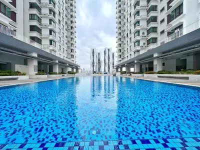 a large blue swimming pool in the middle of a building at Rafflesia KL Big Family 3BR Condo Near LRT in Kuala Lumpur