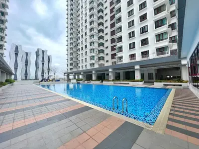 a large swimming pool in the middle of a building at Rafflesia KL Big Family 3BR Condo Near LRT in Kuala Lumpur