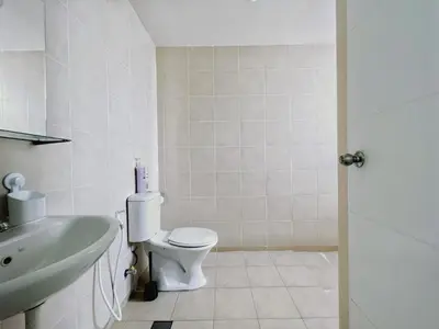 a bathroom with a white toilet and a sink at Rafflesia KL Big Family 3BR Condo Near LRT in Kuala Lumpur