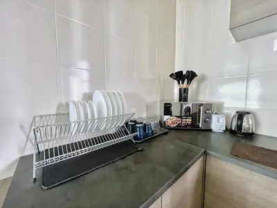 a kitchen counter with white appliances on a counter top at Rafflesia KL Big Family 3BR Condo Near LRT in Kuala Lumpur