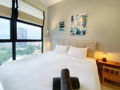 a bedroom with a large white bed with a window at Arte mont kiara by Happy stay in Kuala Lumpur