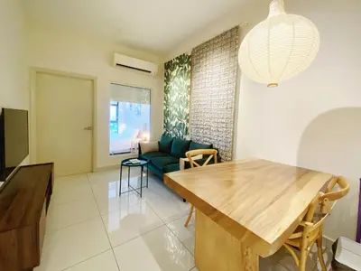 a living room with a table and a couch at Arte mont kiara by Happy stay in Kuala Lumpur