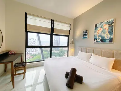 a bedroom with a large white bed with a window at Arte mont kiara by Happy stay in Kuala Lumpur
