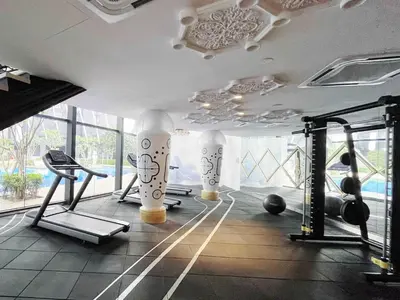 a gym with exercise equipment in a room with windows at Arte mont kiara by Happy stay in Kuala Lumpur