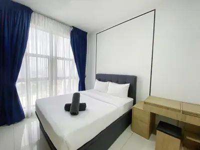 a bedroom with a bed with a black chair on it at Arte mont kiara by Happy stay in Kuala Lumpur