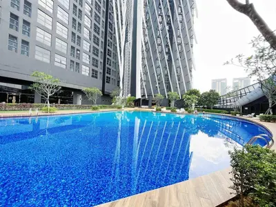 a large blue swimming pool in front of tall buildings at Arte mont kiara by Happy stay in Kuala Lumpur