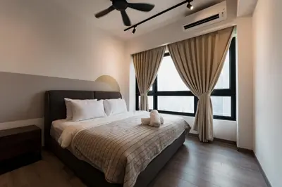 a bedroom with a bed with a teddy bear on it at Agile BB Residence Pavilion TRX by GB in Kuala Lumpur