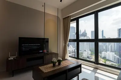 a living room with a tv and a large window at Agile BB Residence Pavilion TRX by GB in Kuala Lumpur