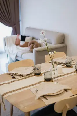 a wooden table with a vase of flowers on it at Agile BB Residence Pavilion TRX by GB in Kuala Lumpur