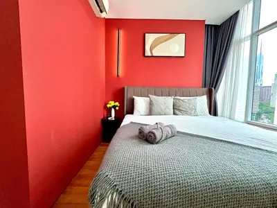 a red bedroom with a bed and a window at Sky Suites Lovely 3BR Suite at KLCC in Kuala Lumpur