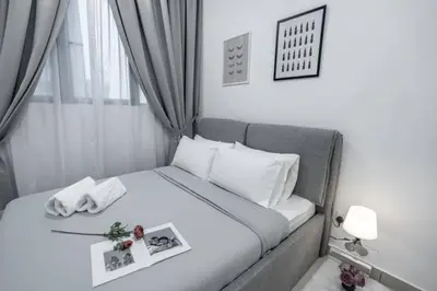 a small bedroom with a white bed with a tray on it at Trion KL - 2 Bedroom, 5 pax, Netflix, Free Car Park in Kuala Lumpur