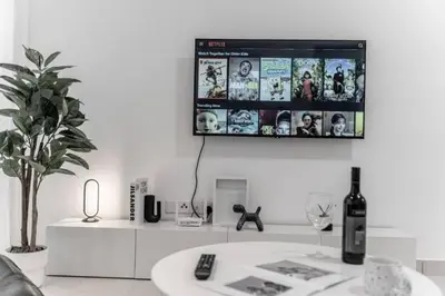a living room with a flat screen tv on the wall at Trion KL - 2 Bedroom, 5 pax, Netflix, Free Car Park in Kuala Lumpur
