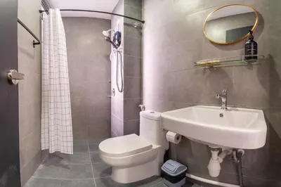 a bathroom with a sink and a toilet and a mirror at Neu Suites By Cozy Unit L20RA near KLCC & Jelatek LRT in Kuala Lumpur