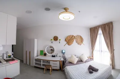 a bedroom with a bed and a desk and a sink at Neu Suites By Cozy Unit L20RA near KLCC & Jelatek LRT in Kuala Lumpur