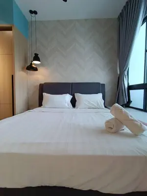 a large white bed with a pair of towels on it at COL18B Modern Infinity Pool KLCC Balcony View in Kuala Lumpur