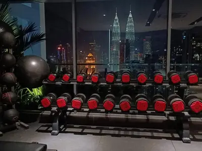 a bunch of red wine bottles in a room with a city at COL18B Modern Infinity Pool KLCC Balcony View in Kuala Lumpur