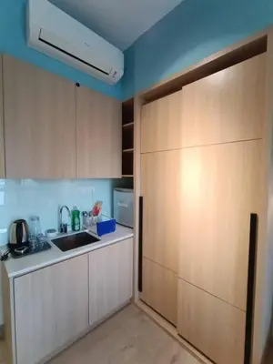 a kitchen with a sink and a large sliding door at COL18B Modern Infinity Pool KLCC Balcony View in Kuala Lumpur