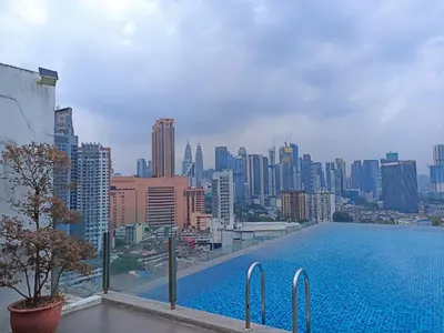 a swimming pool with a city skyline in the background at D'Majestic Place in Kuala Lumpur