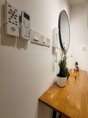 a bathroom with a mirror and a table with a plant at COL 14B Modern Infinity Pool KLCC Balcony View in Kuala Lumpur