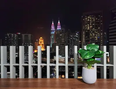 a white fence with a potted plant in front of a city skyline at COL 14B Modern Infinity Pool KLCC Balcony View in Kuala Lumpur