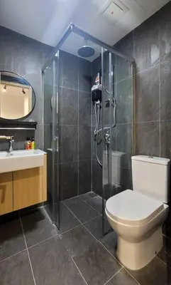 a bathroom with a shower and a toilet and a sink at COL 14B Modern Infinity Pool KLCC Balcony View in Kuala Lumpur
