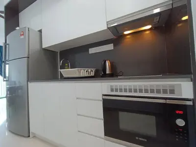 a kitchen with a stove and a refrigerator at LUX 39A Balcony KLCC View 1 Bedroom Infinity Pool in Kuala Lumpur