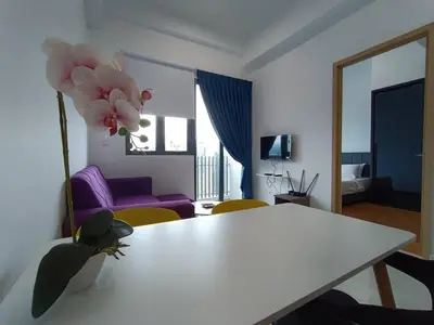 a living room with a white table and a purple couch at LUX 39A Balcony KLCC View 1 Bedroom Infinity Pool in Kuala Lumpur
